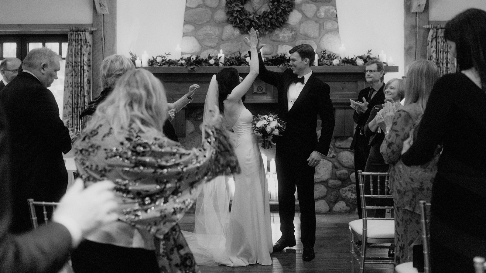 High fives to celebrate getting married at a winter sunset Post Hotel wedding
