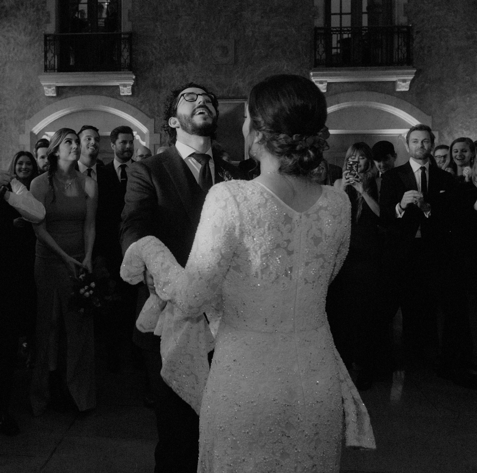 Groom throwing his head back in joy during first dance