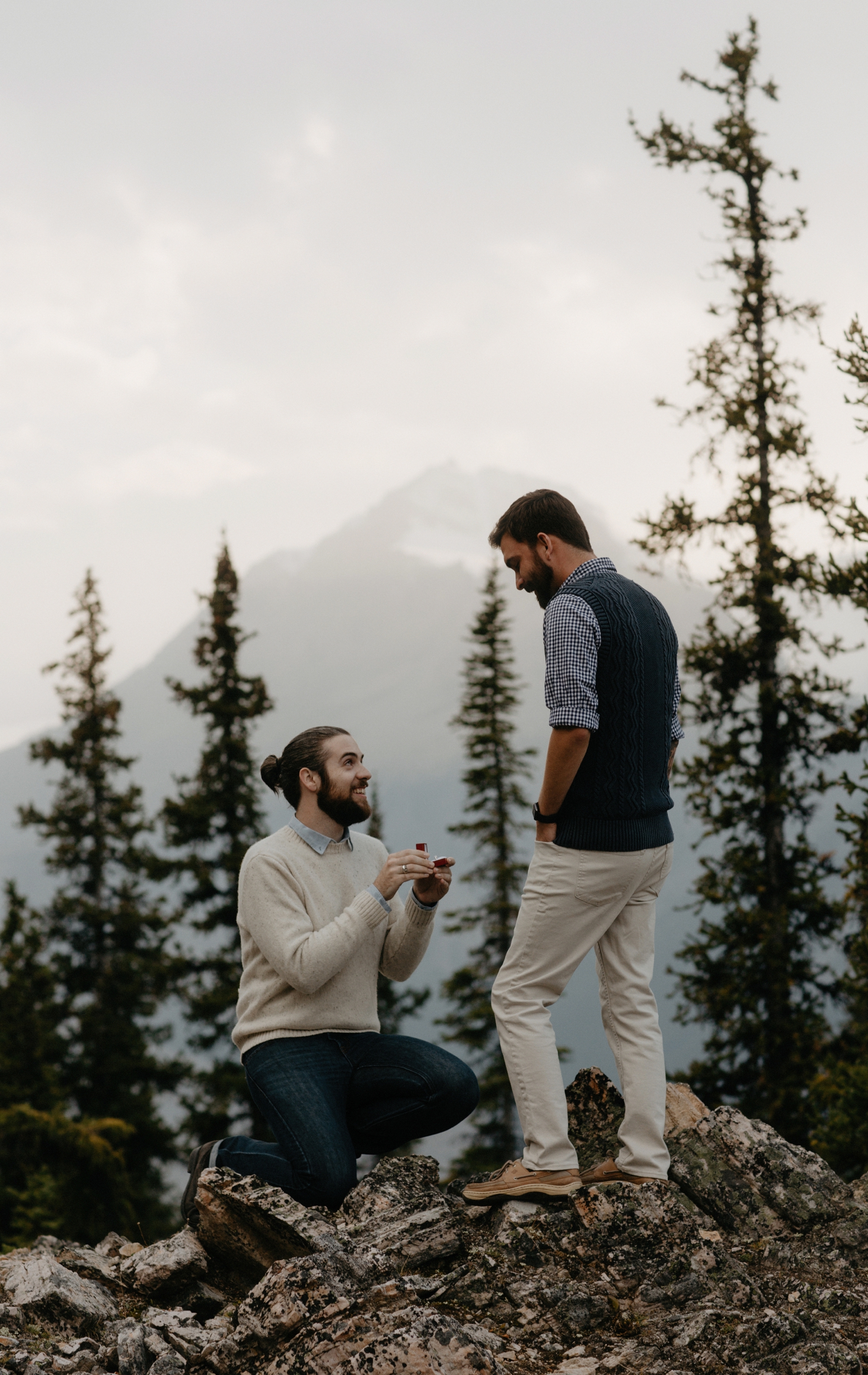 A man proposing to his boyfriend in a rockfield along the Icefields Parkway