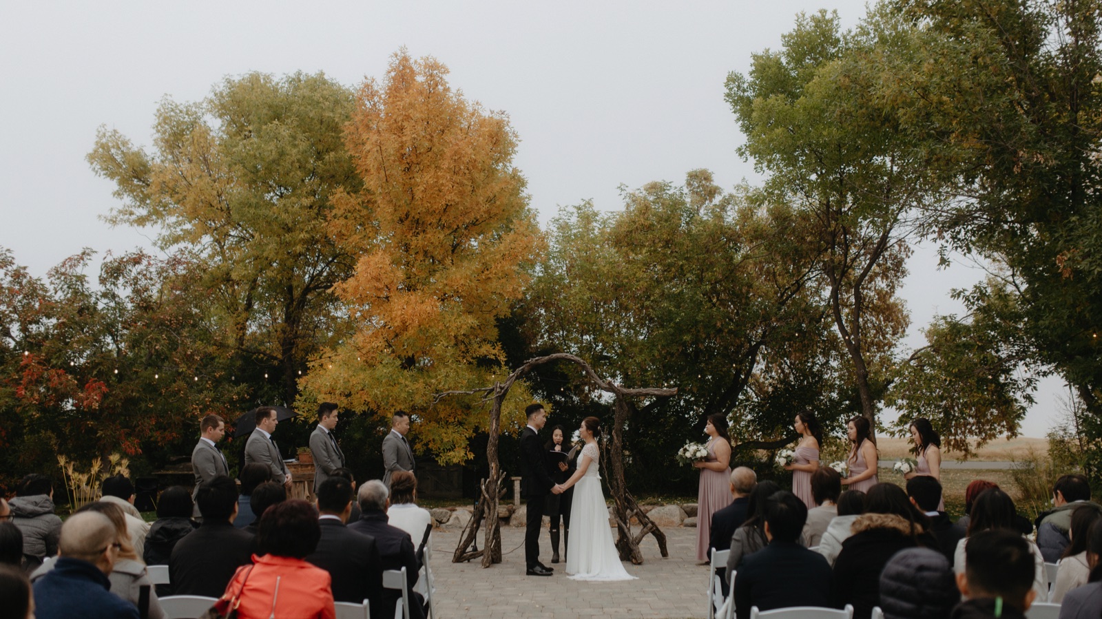 Unique ceremony twisted wooden arch for a fall wedding south of Calgary