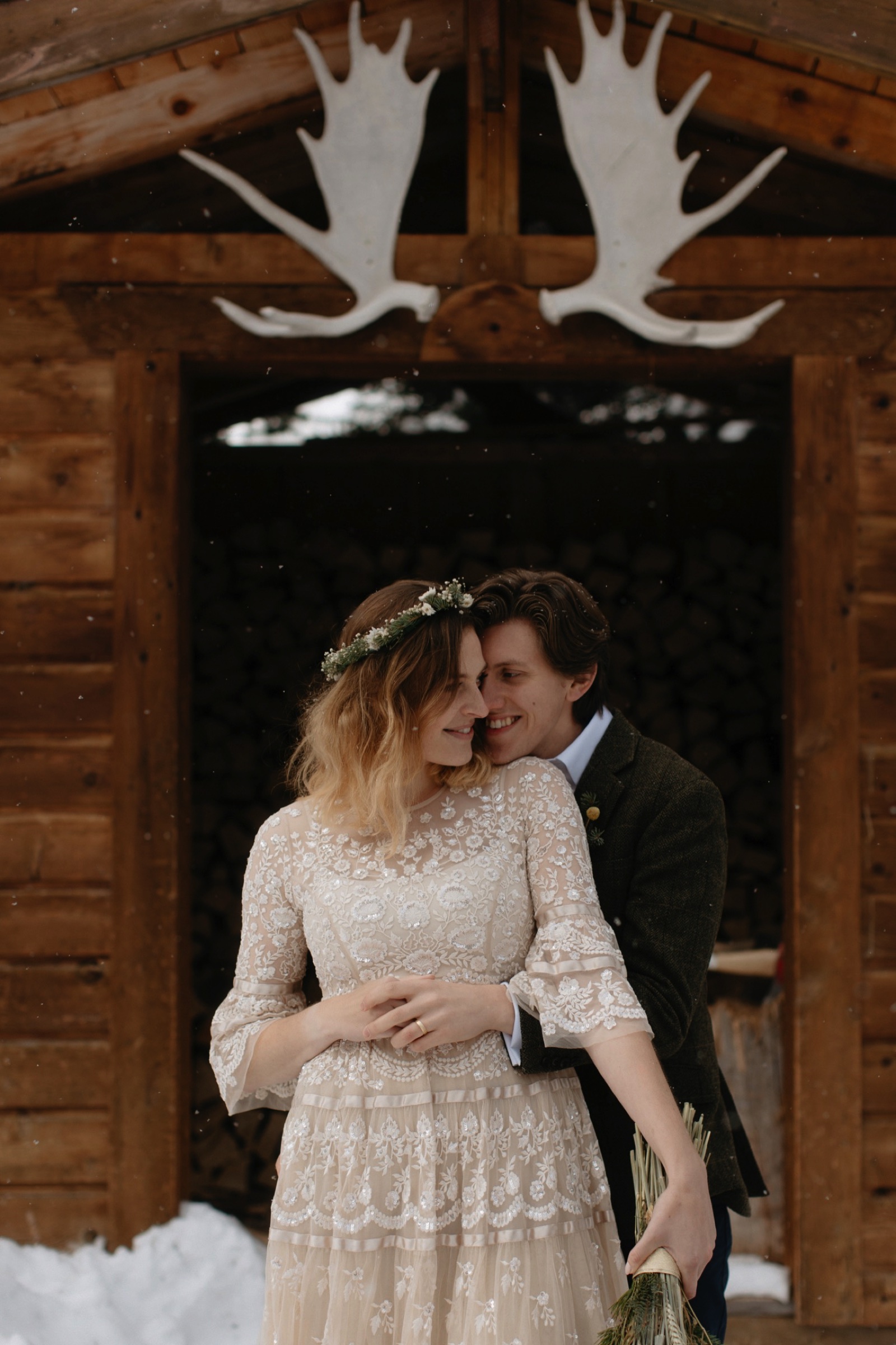 Rustic and timeless portrait of a wedding couple with the bride wearing a sequenced Needle and Thread dress and handmade floral crown