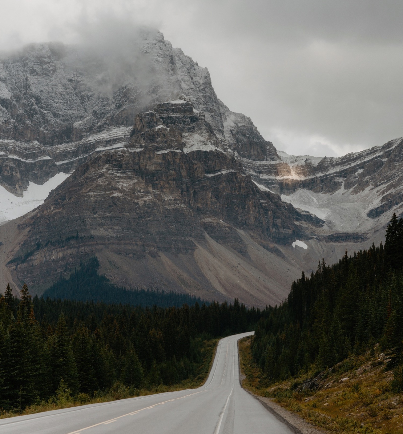 Views of mountains and glaciers in clouds along the Icefields Parkway