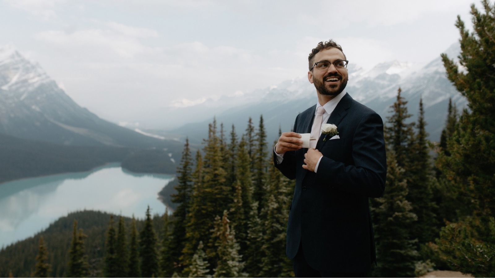 Groom seeing his bride for the first time before their standing ceremony overlooking Peyto Lake