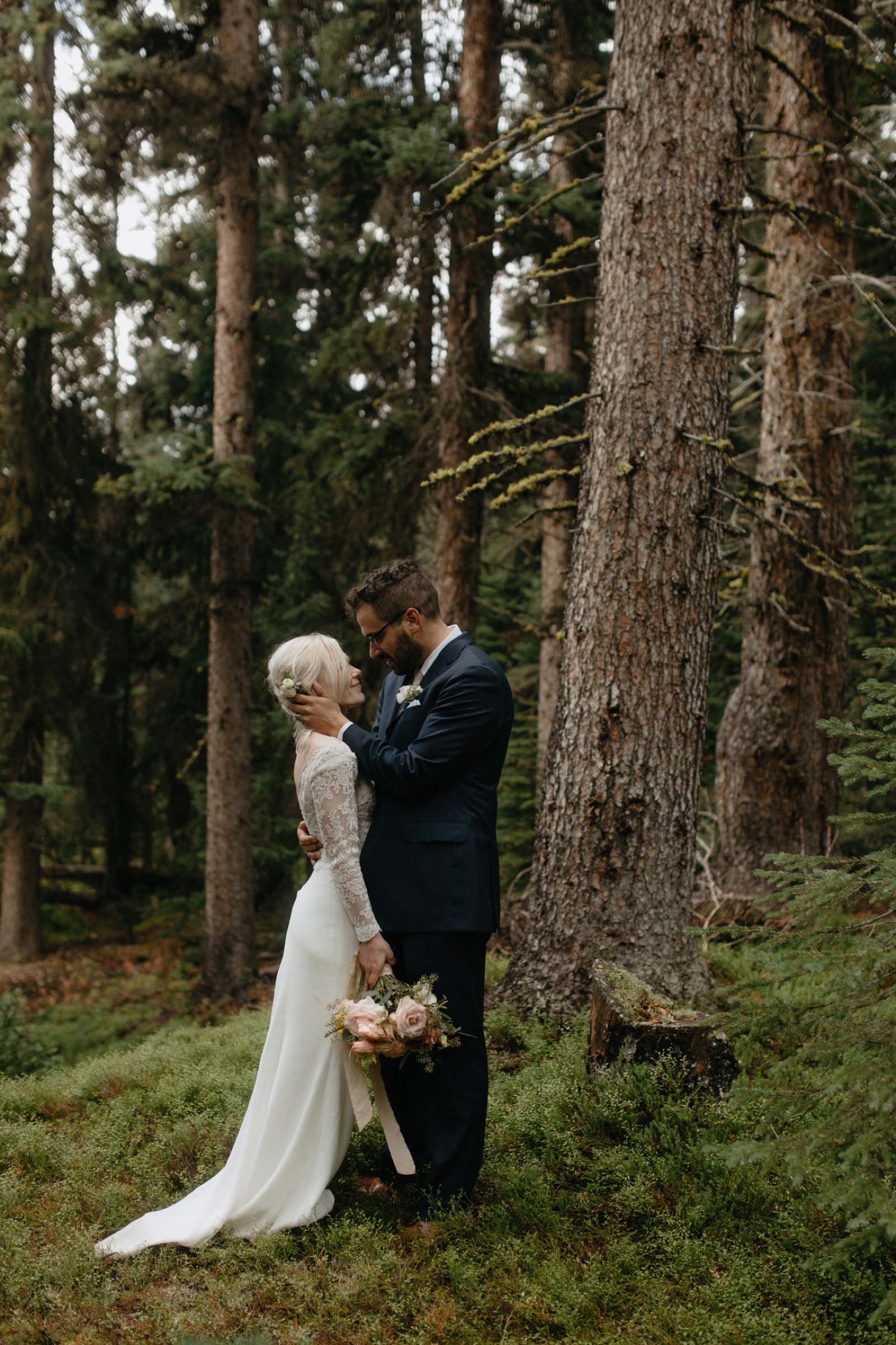 Old forest wedding portraits with a couple embracing