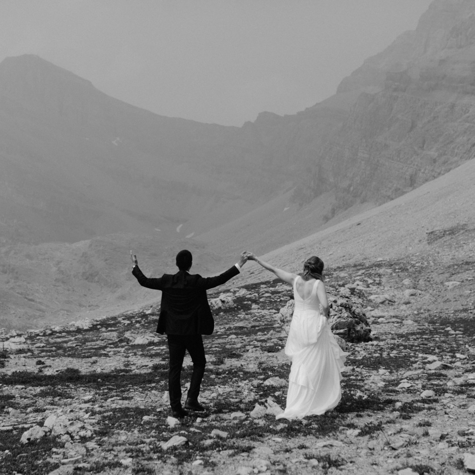 Hiking wedding photography in glacial moraine by Skoki Lodge in the Banff backcountry