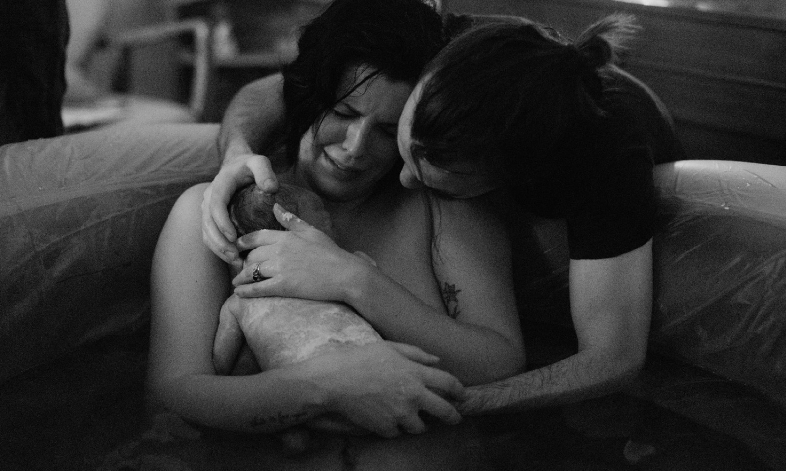 Emotional black and white birth photography moment after daughter is born