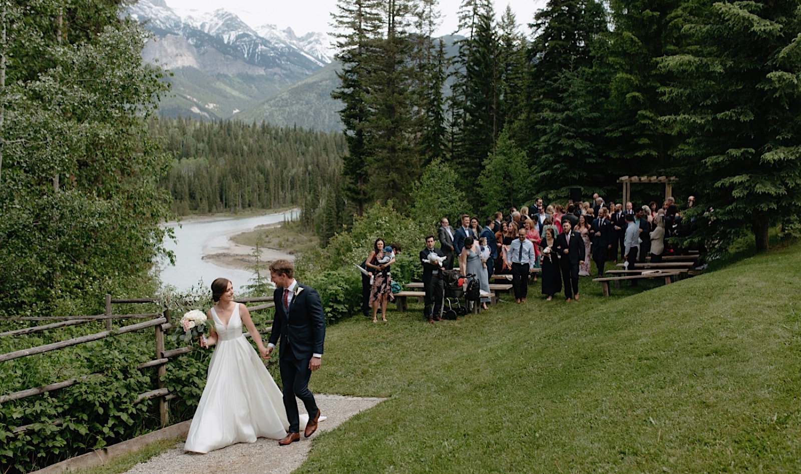Wedding couple leaving their scenic ceremony in Golden British Columbia