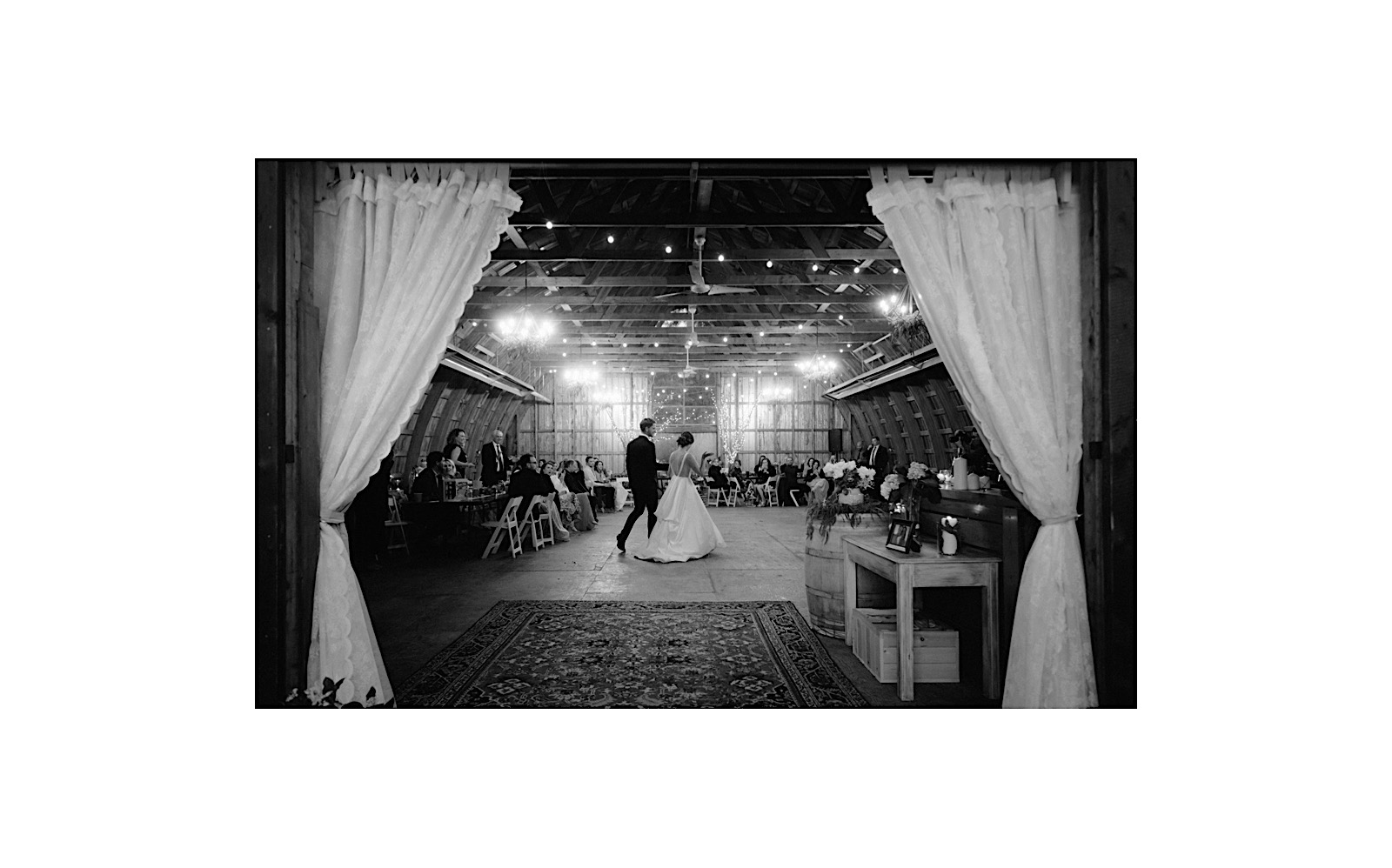 First dance in the barn at Hillside Lodge with couple walking hand in hand