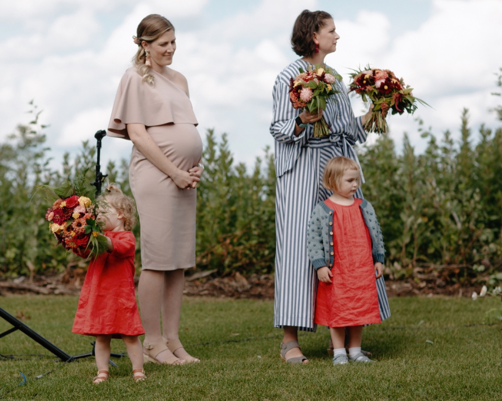 Flower girls in home-made red frocks reminiscent of 1920s