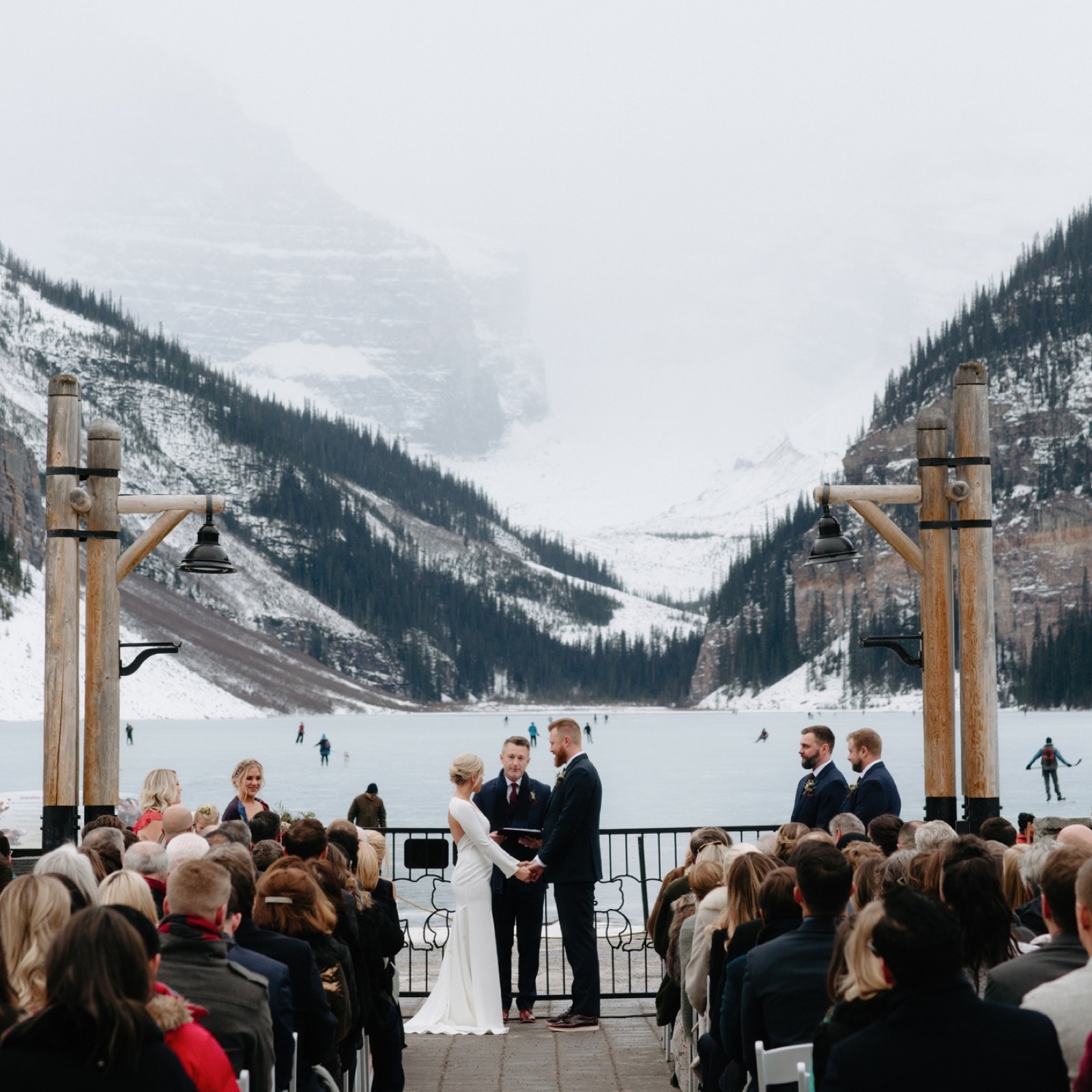 Winter Outdoor Terrace wedding ceremony with a hockey backdrop overlooking the Victoria Glacier in Lake Louise, Banff