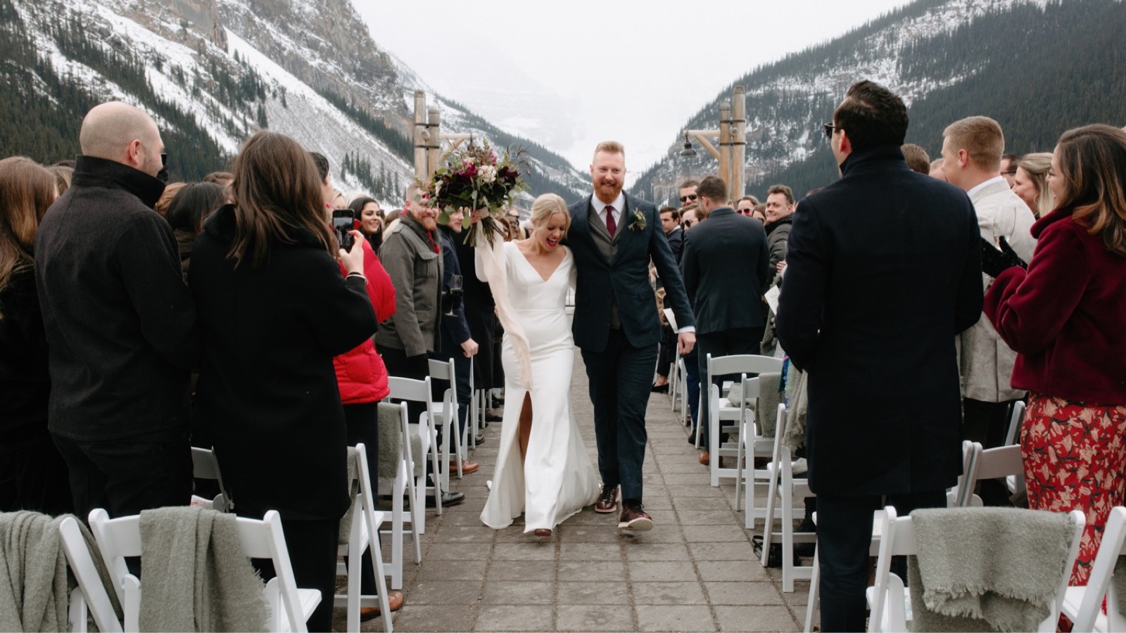 The best way to celebrate newly being married, a couple during their recessional in Lake Louise
