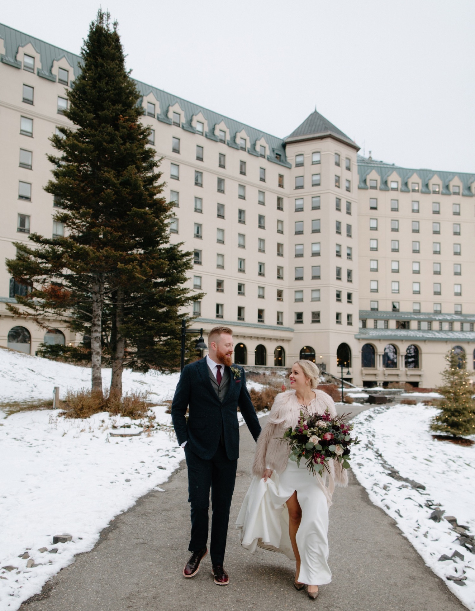 Winter wedding couple with classic and unique style at the Chateau Lake Louise in Banff