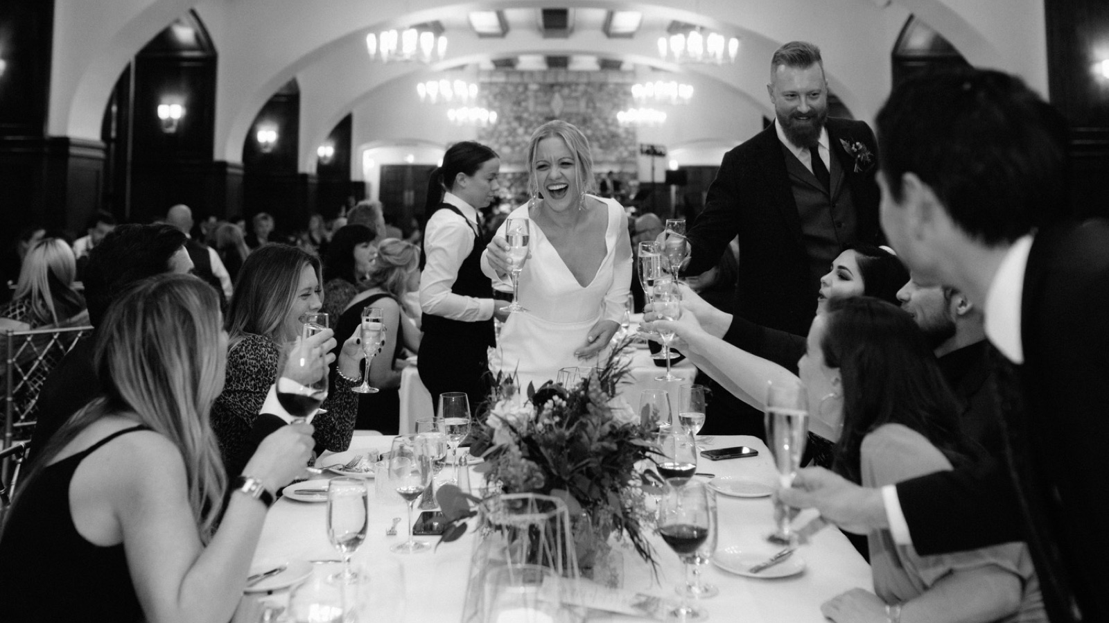 Couple cheersing their guests at their intimate wedding reception in Lake Louise