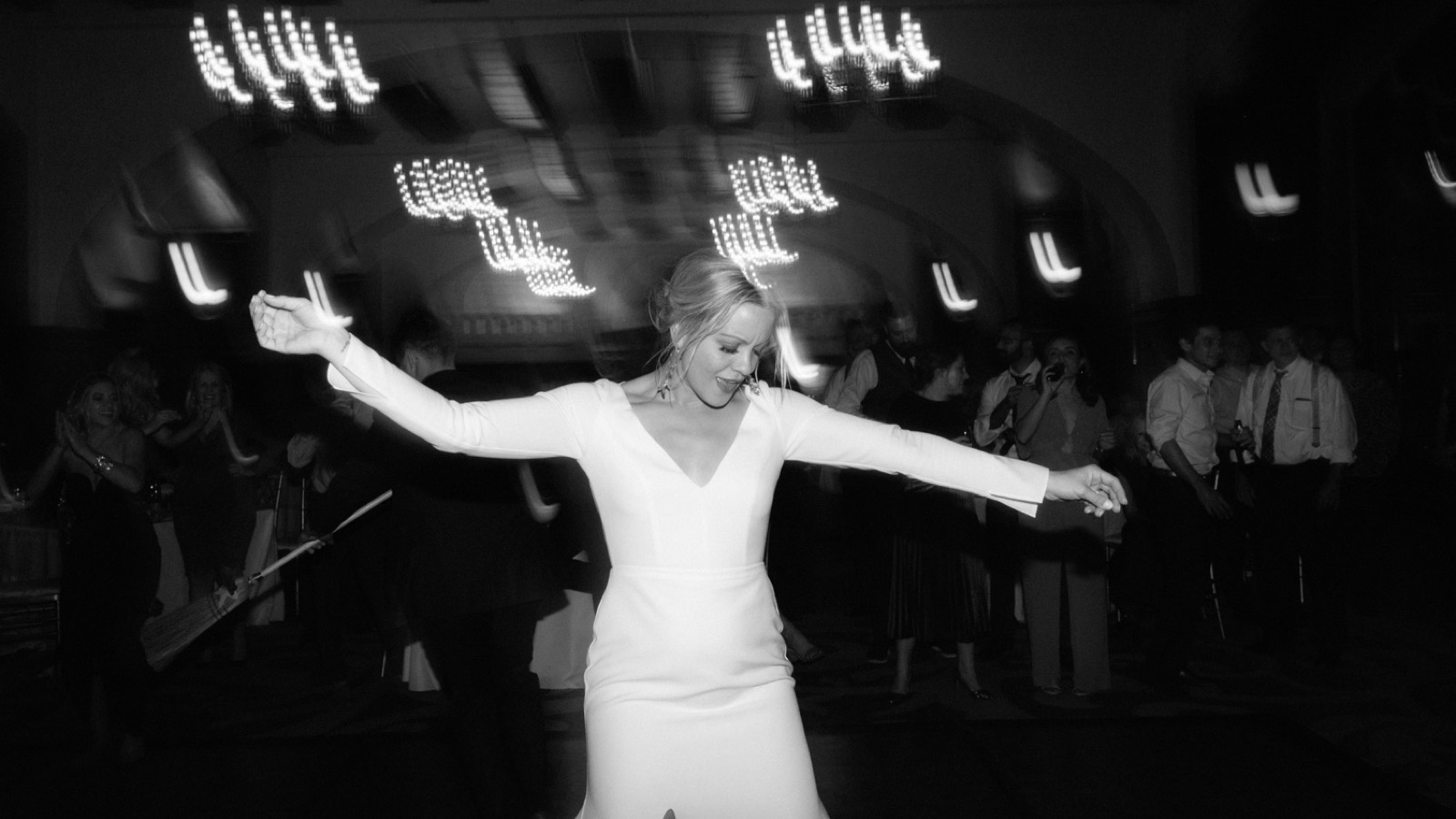 Bride in a classic white Sarah Seven long-sleeved dress ripping up the dancefloor in the Victoria Ballroom alongside Lake Louise