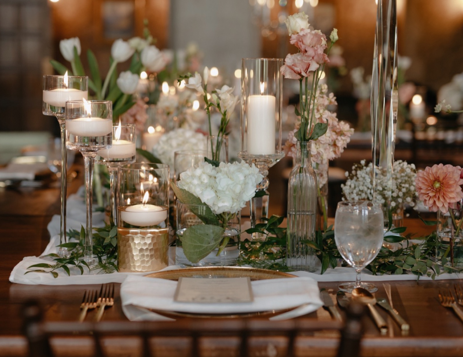 Gold, ivory and pink wedding details with floating candles for a long table reception table setup in Banff