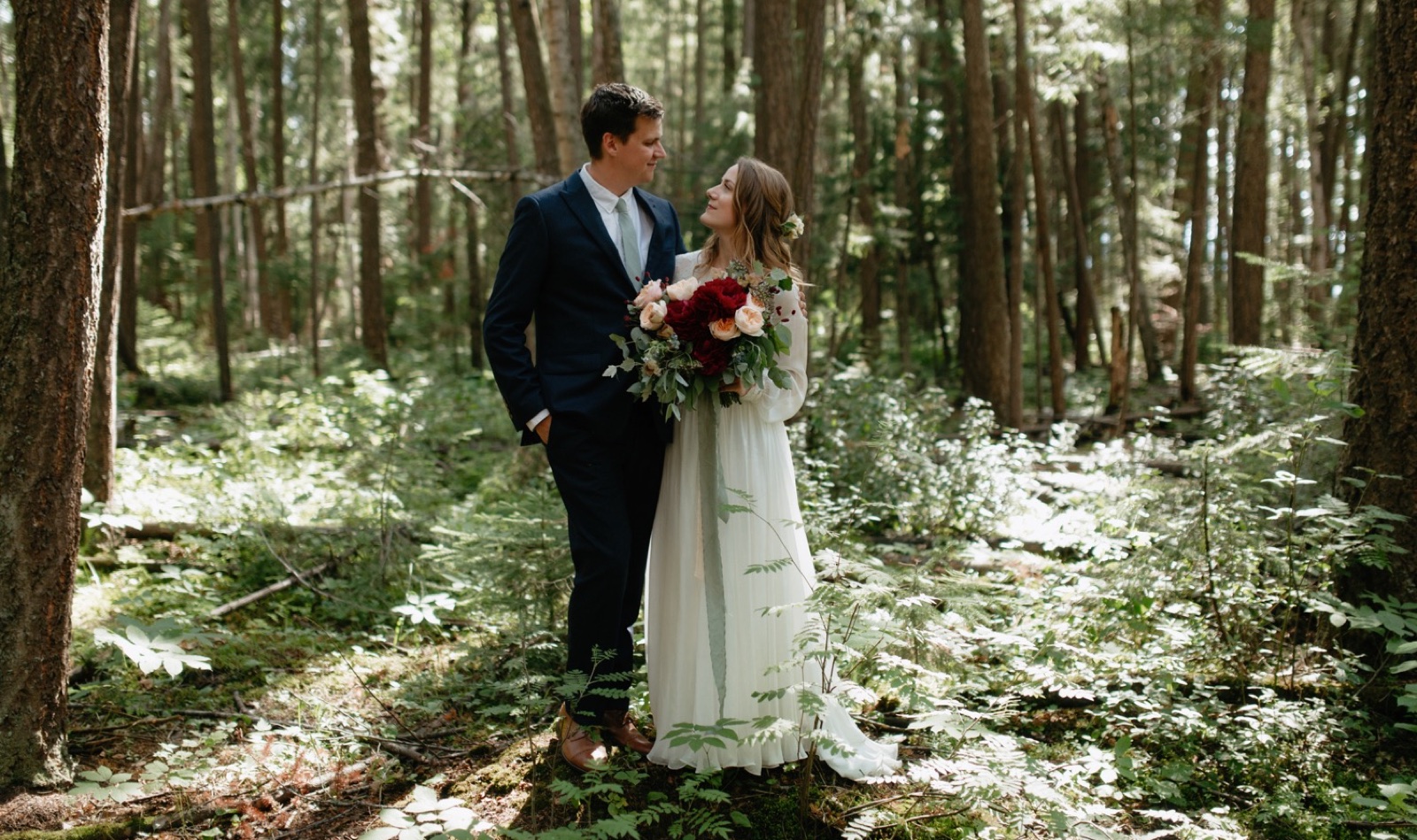 Wedding portraits with colourful maroon florals in LC Gunn Park in Prince George
