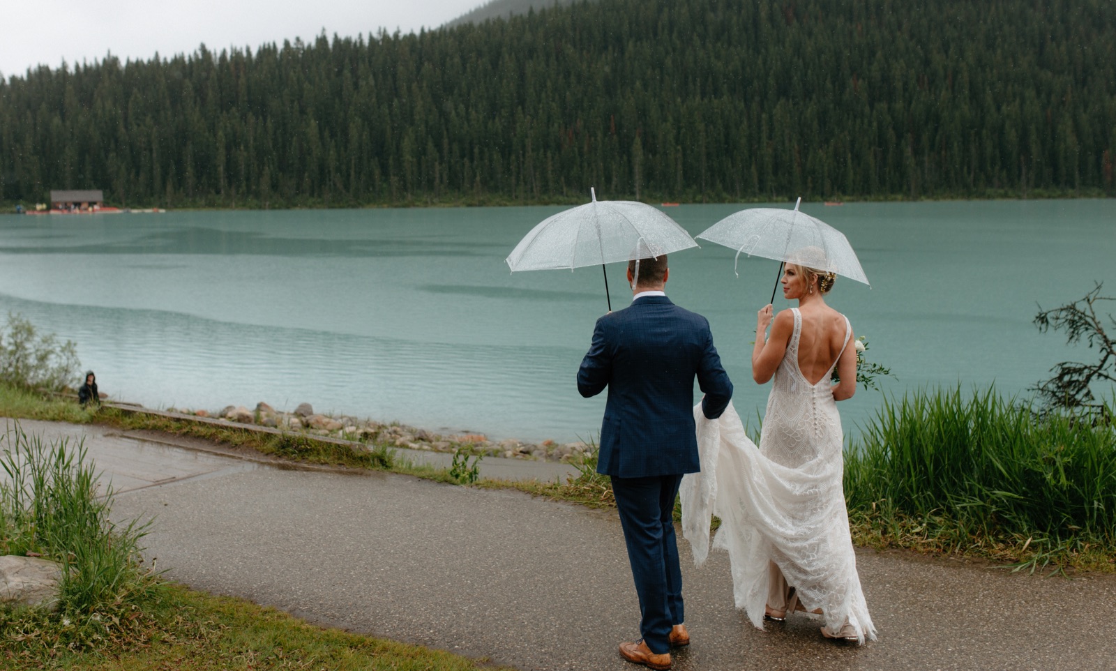 Rainy Lake Louise wedding inspiration with clear umbrellas