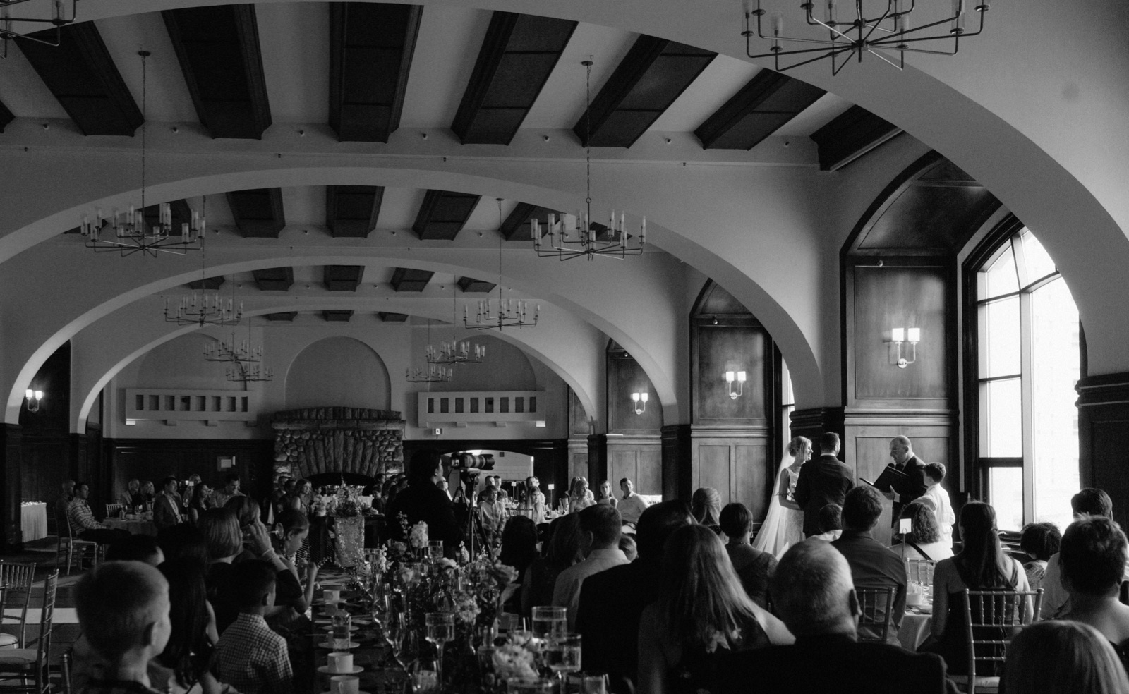 Victoria Ballroom ceremony with guests seated at dinner tables for a rainy July wedding