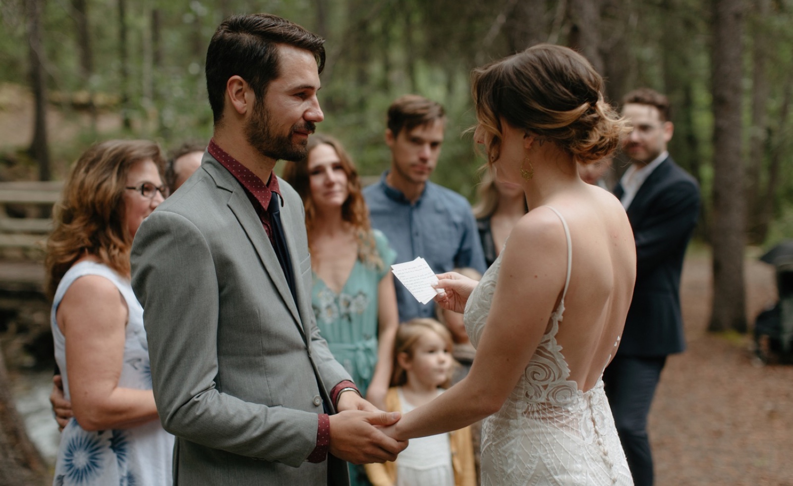 Groom tenderly looking at his bride during their handwritten vows in a secluded canyon in Banff