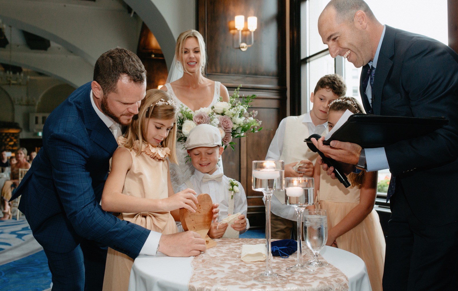 Blended family wedding tradition of arranging wooden heart pieces
