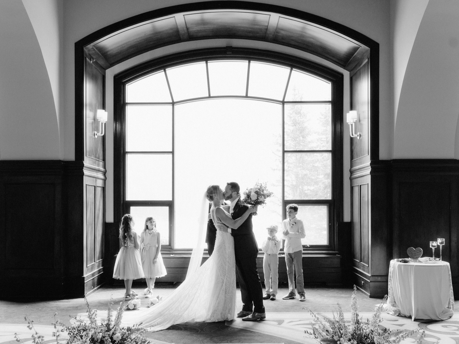 Indoor Victoria Ballroom wedding ceremony with window backdrop at Lake Louise