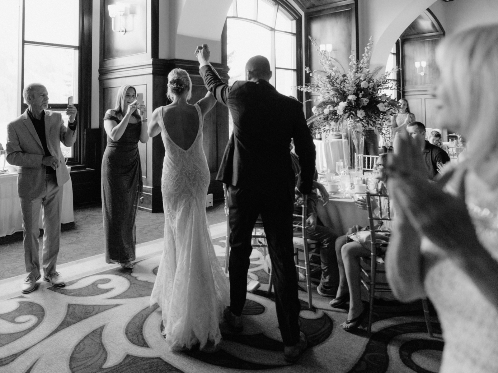 Grand entrance with guests applauding into the Victoria Ballroom for a wedding reception