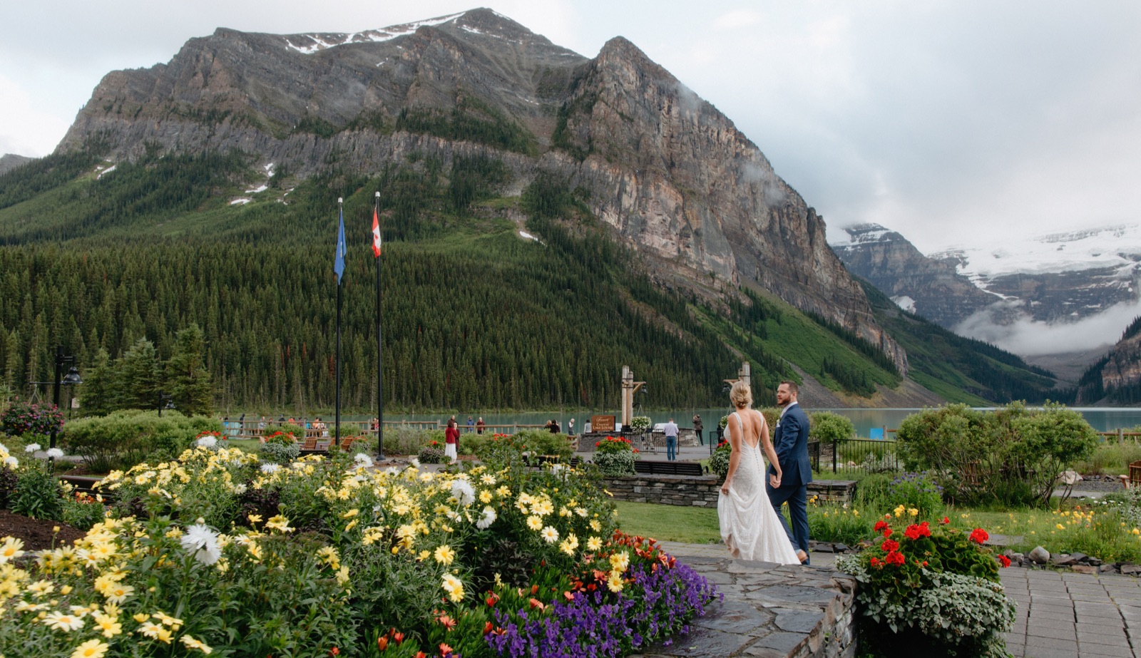 Wedding couple leaving the garden behind Chateau Lake Louise for evening portraits