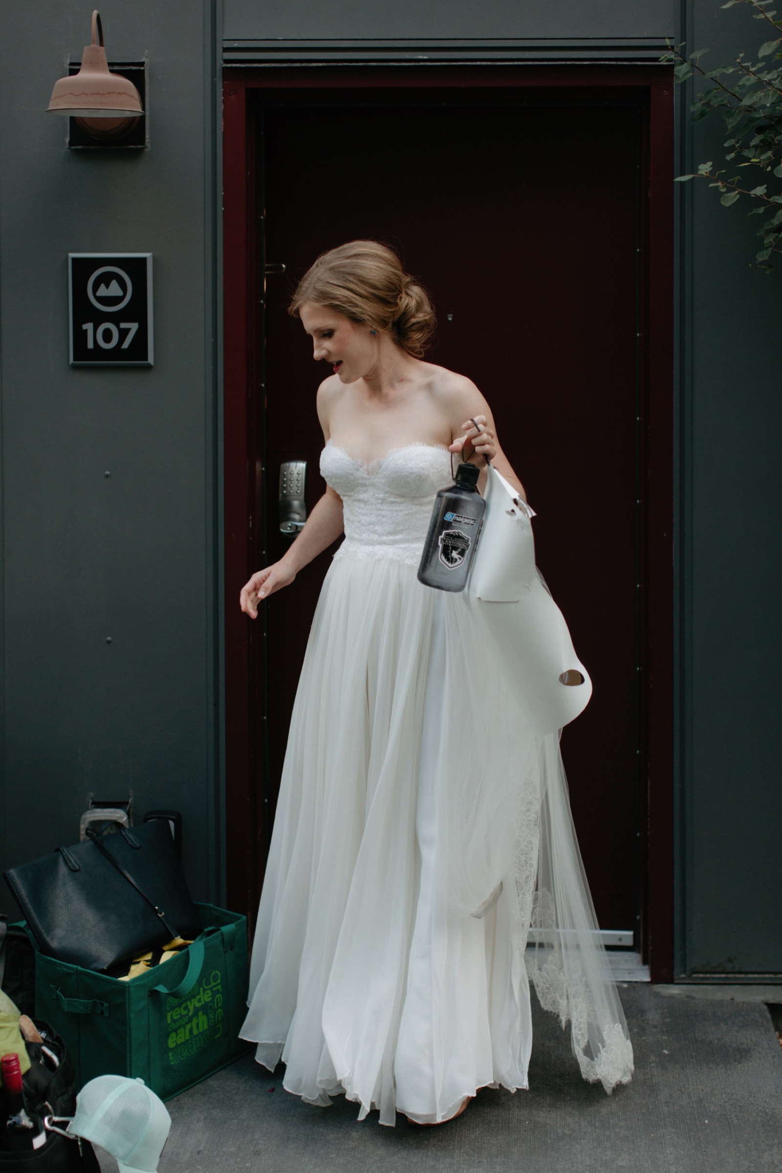 Bride leaving basecamp holding nalgene bottle