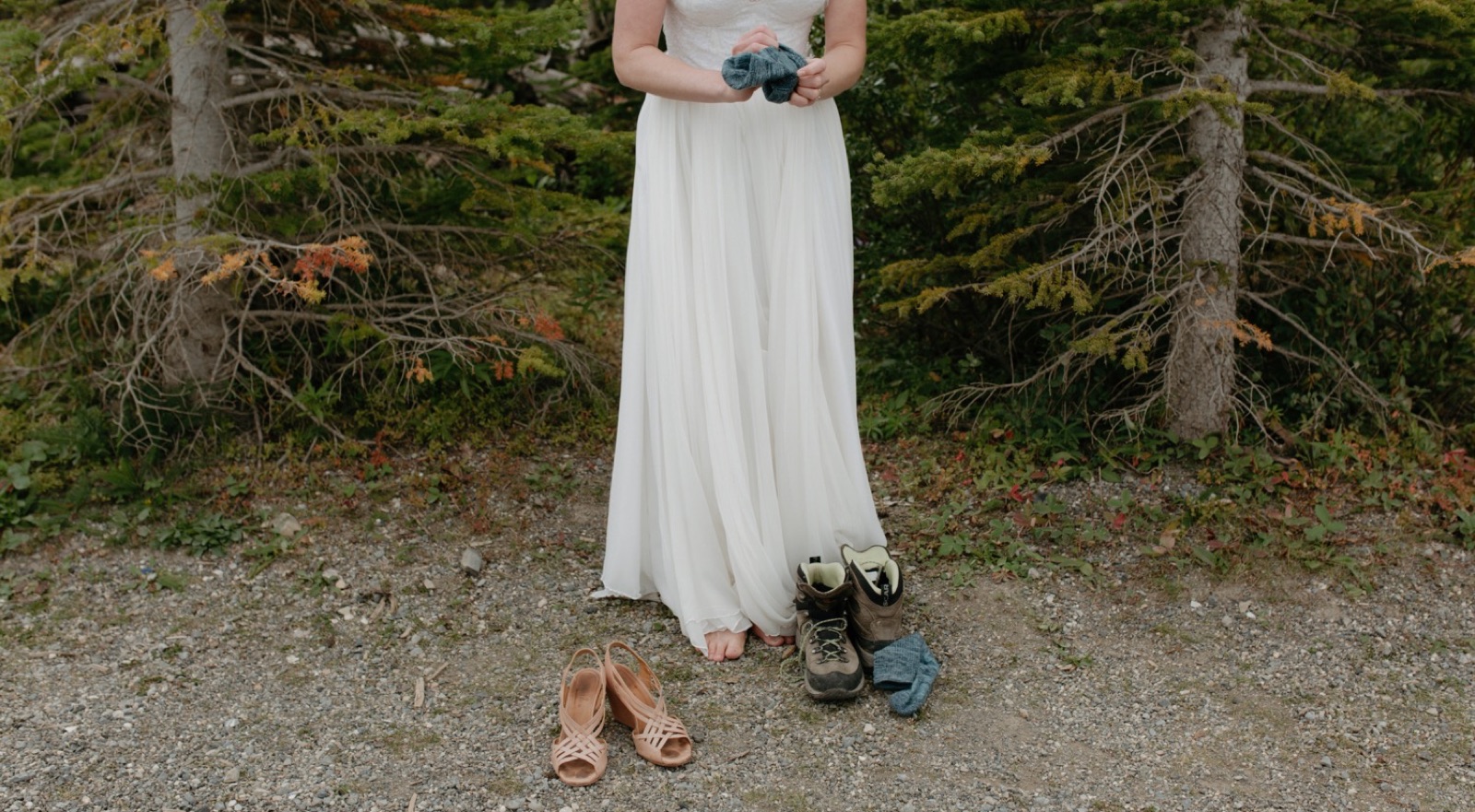 Elopement bride switching at ceremony location from heels to hiking boots