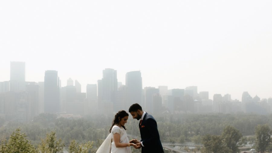 Couple overlooking smokey downtown Calgary
