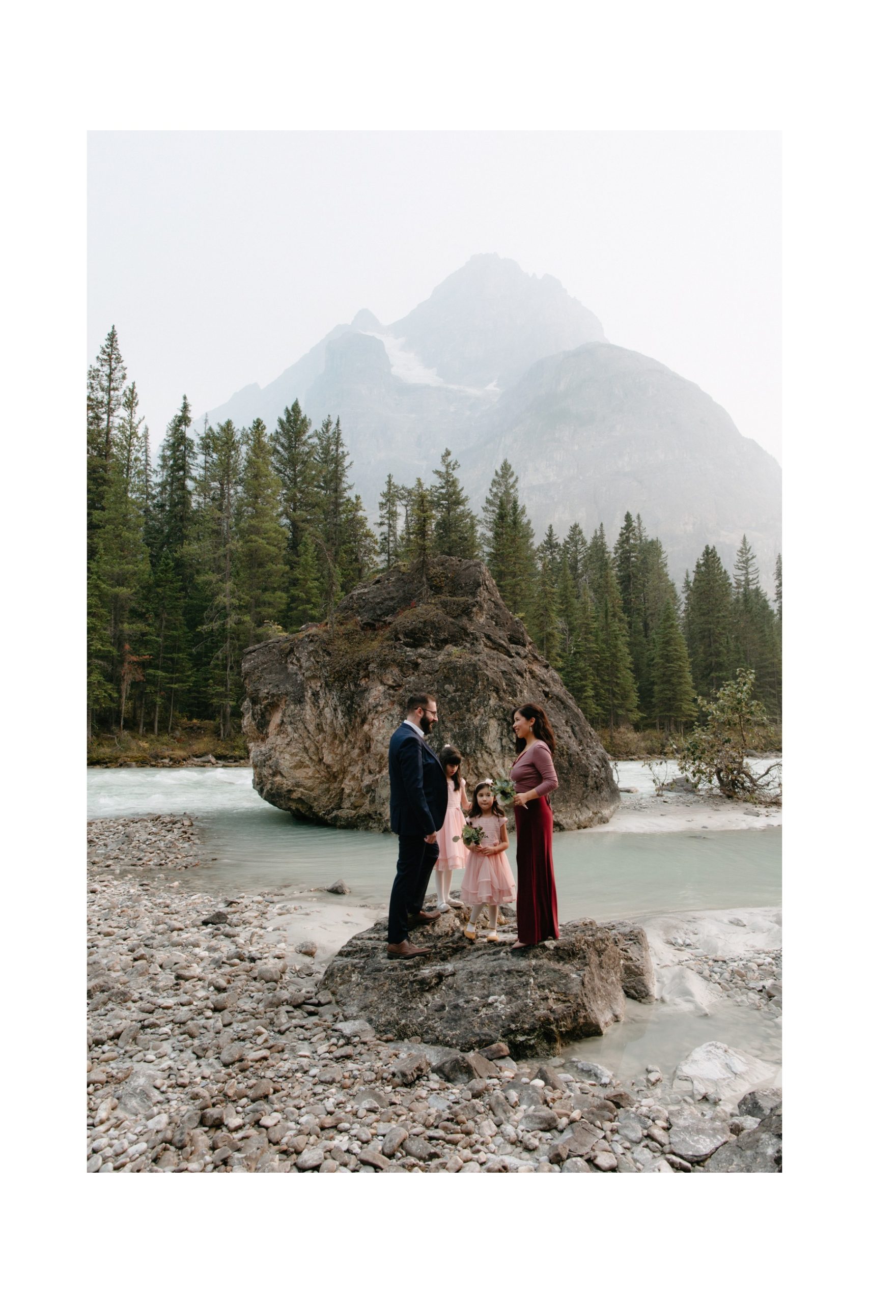 Family vow renewal in Banff National Park with parents exchanging vows with their daughters look on