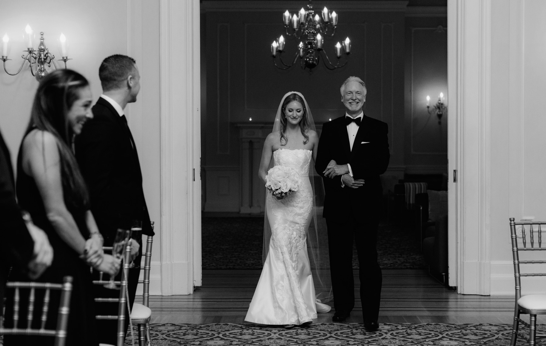 Father walking his daughter down the aisle at an indoor black tie ceremony at The Vancouver Club
