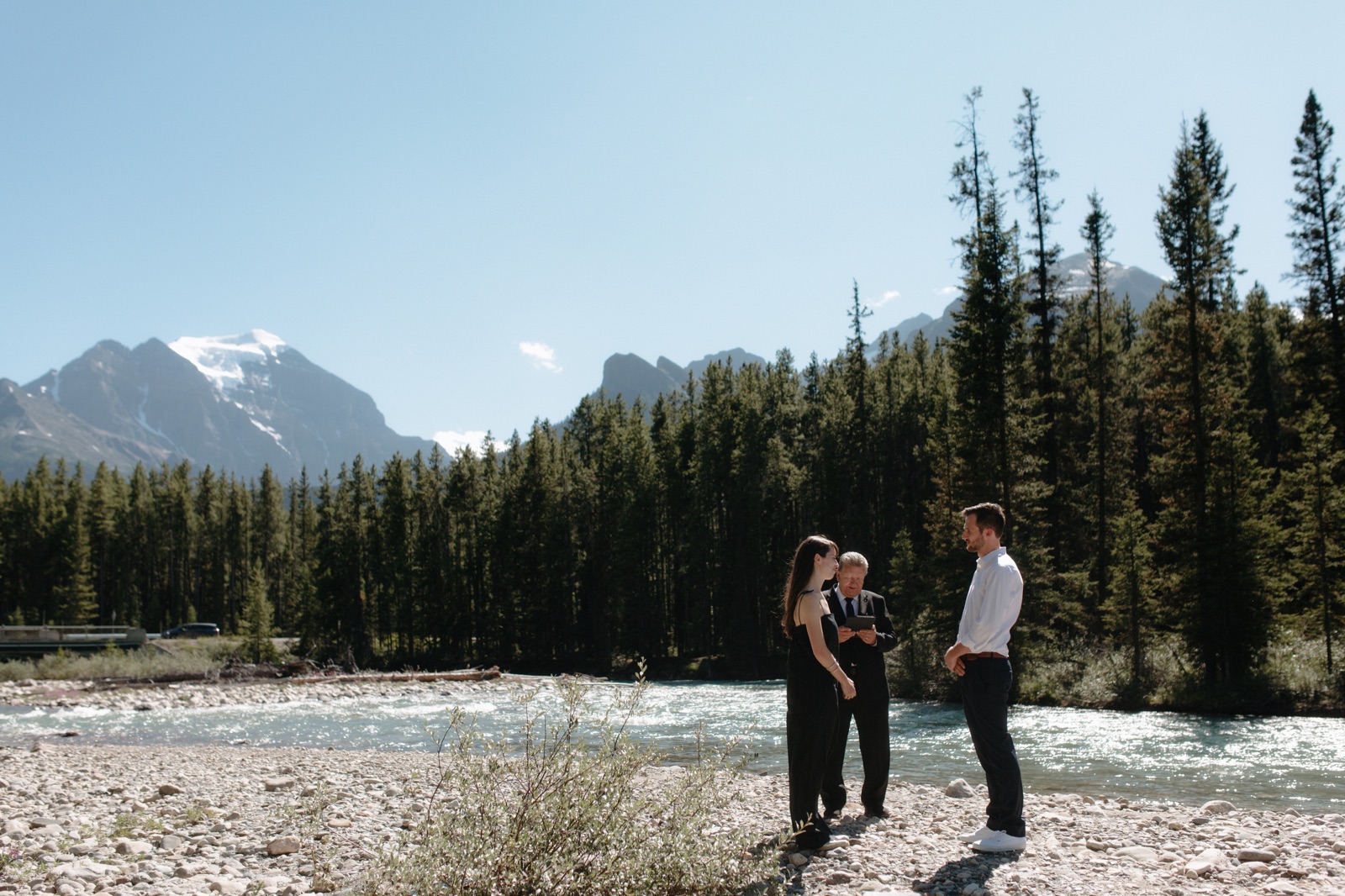 Elopement ceremony at the meeting of the Pipestone River and Bow River by the Post Hotel