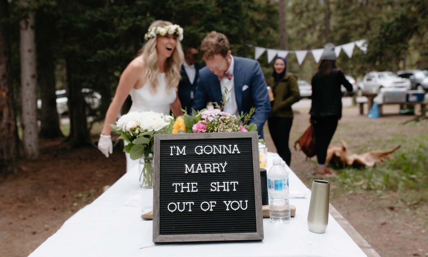 I'm Gonna Marry the Shit Out of You sign at an outdoor elopement reception