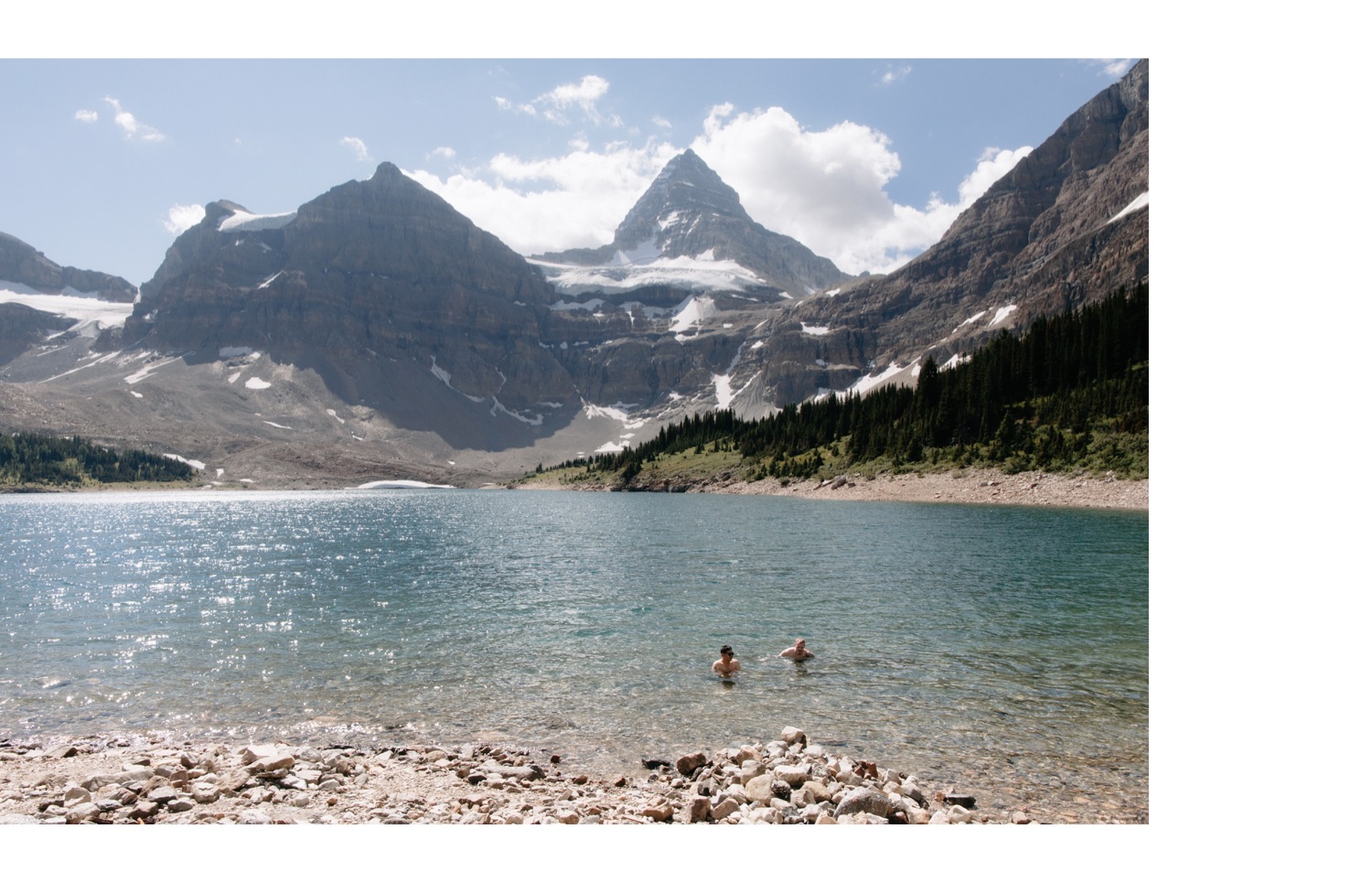Two men swimming in Lake Magog near the backcountry campground beneath Mount Assiniboine