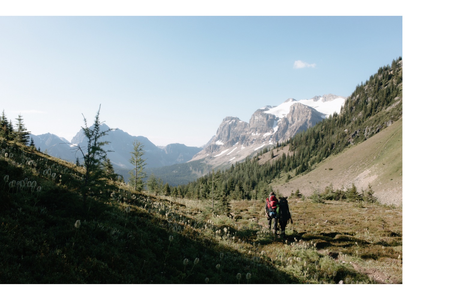 Two hikers walking through Wonder Pass towards Marvel Lake when leaving Mount Assiniboine Provincial Park in August
