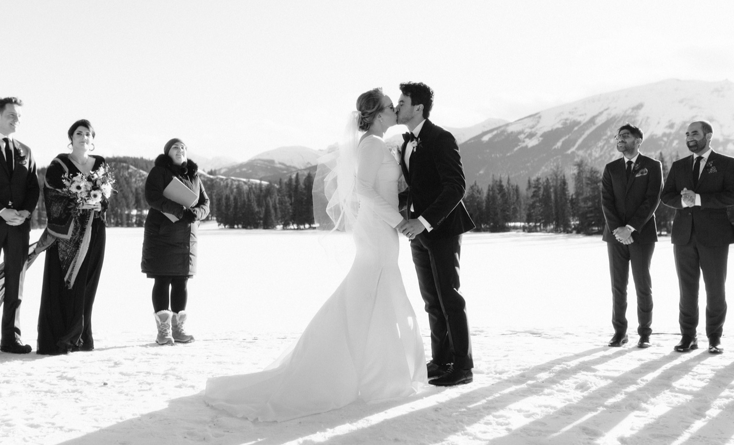 Timeless first kiss at Jasper Park Lodge outdoor winter wedding