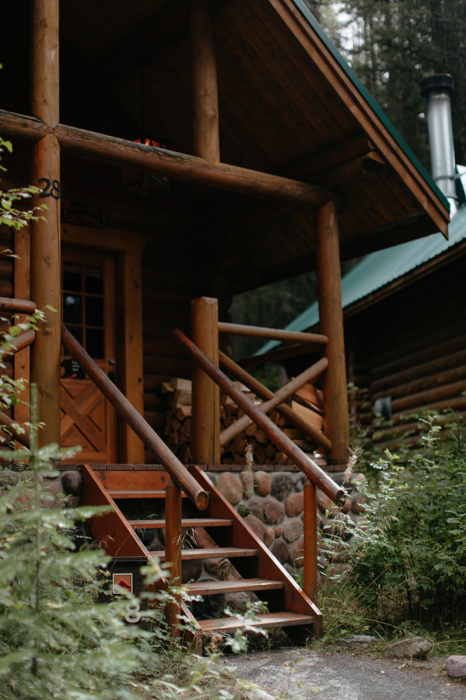 Wooden steps of Cabin 18 at Cathedral Mountain Lodge below Mount Stephen