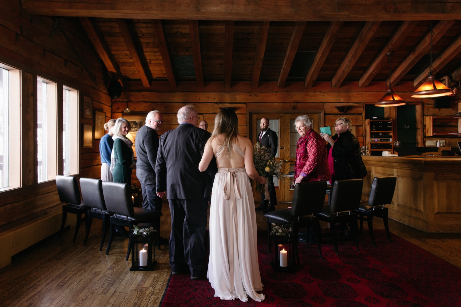 Bride walking arm in arm with her father for their Yoho Lounge elopement ceremony at Emerald Lake