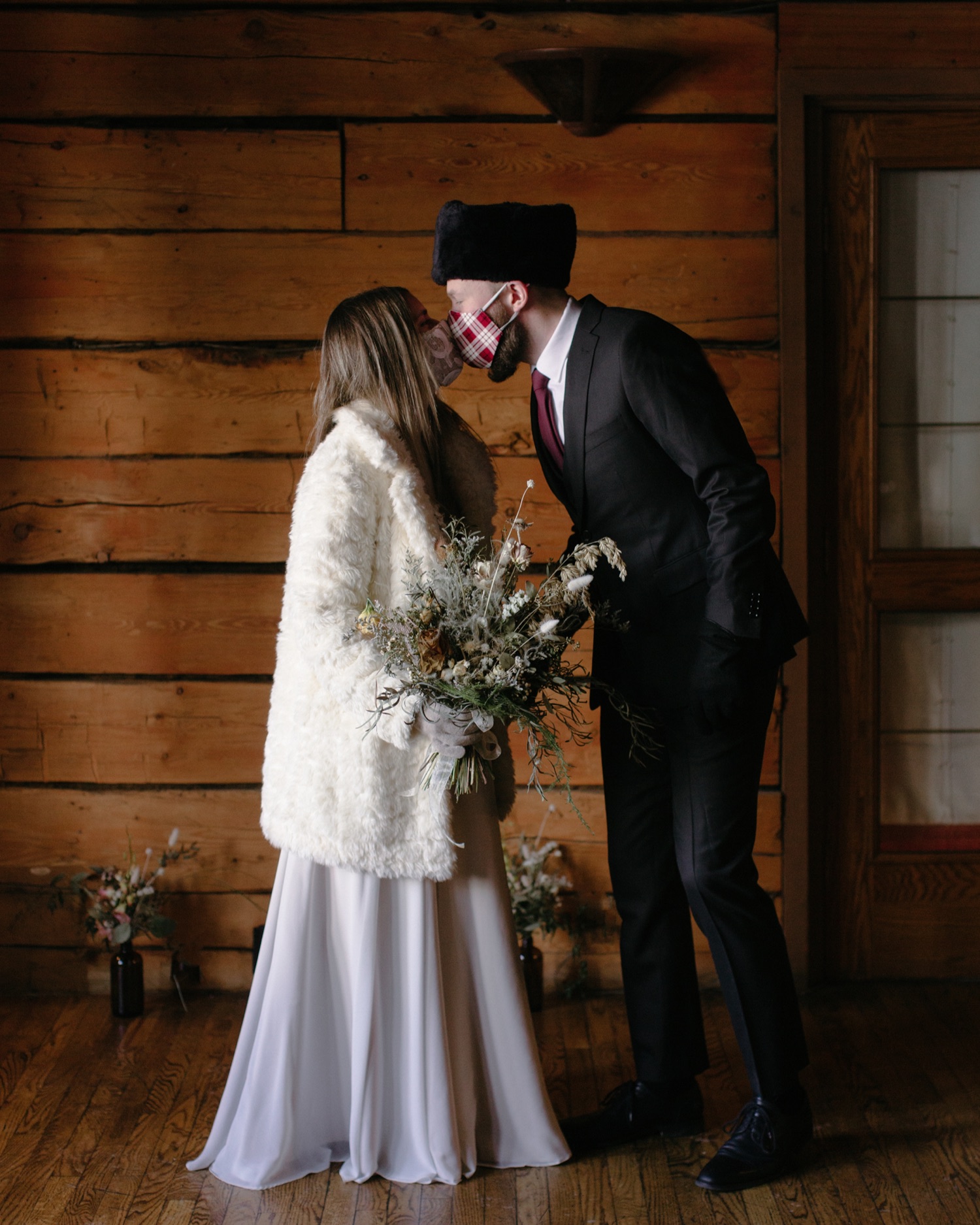 COVID wedding with couple kissing wearing custom masks to match their dress and suit