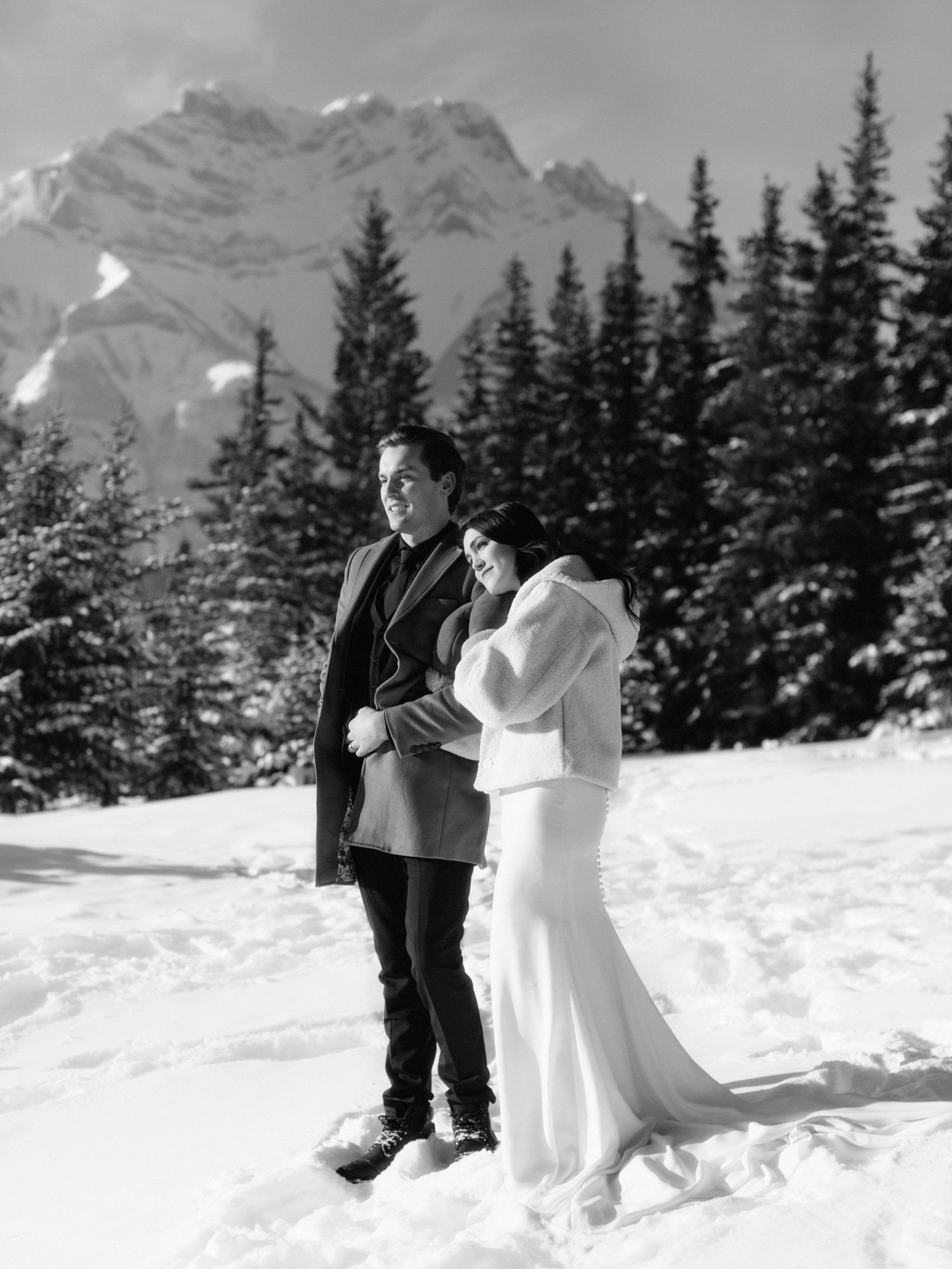 Classic black and white photo of newly eloped couple snuggling with Cascade Mountain backdrop