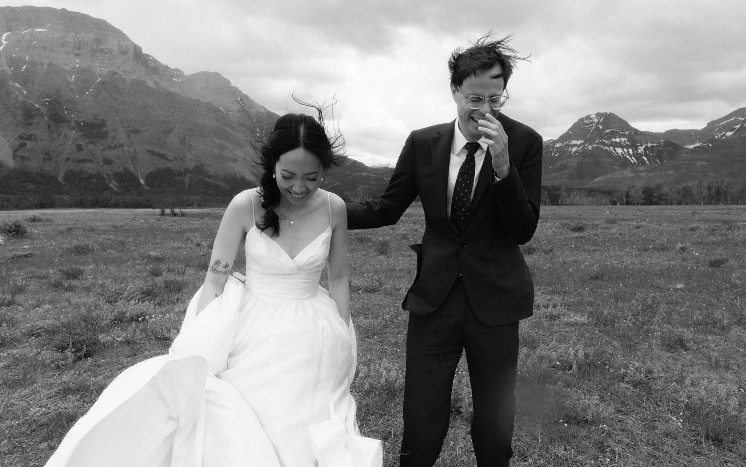 Windy wedding portraiture in the lupine field in Waterton Lakes National Park