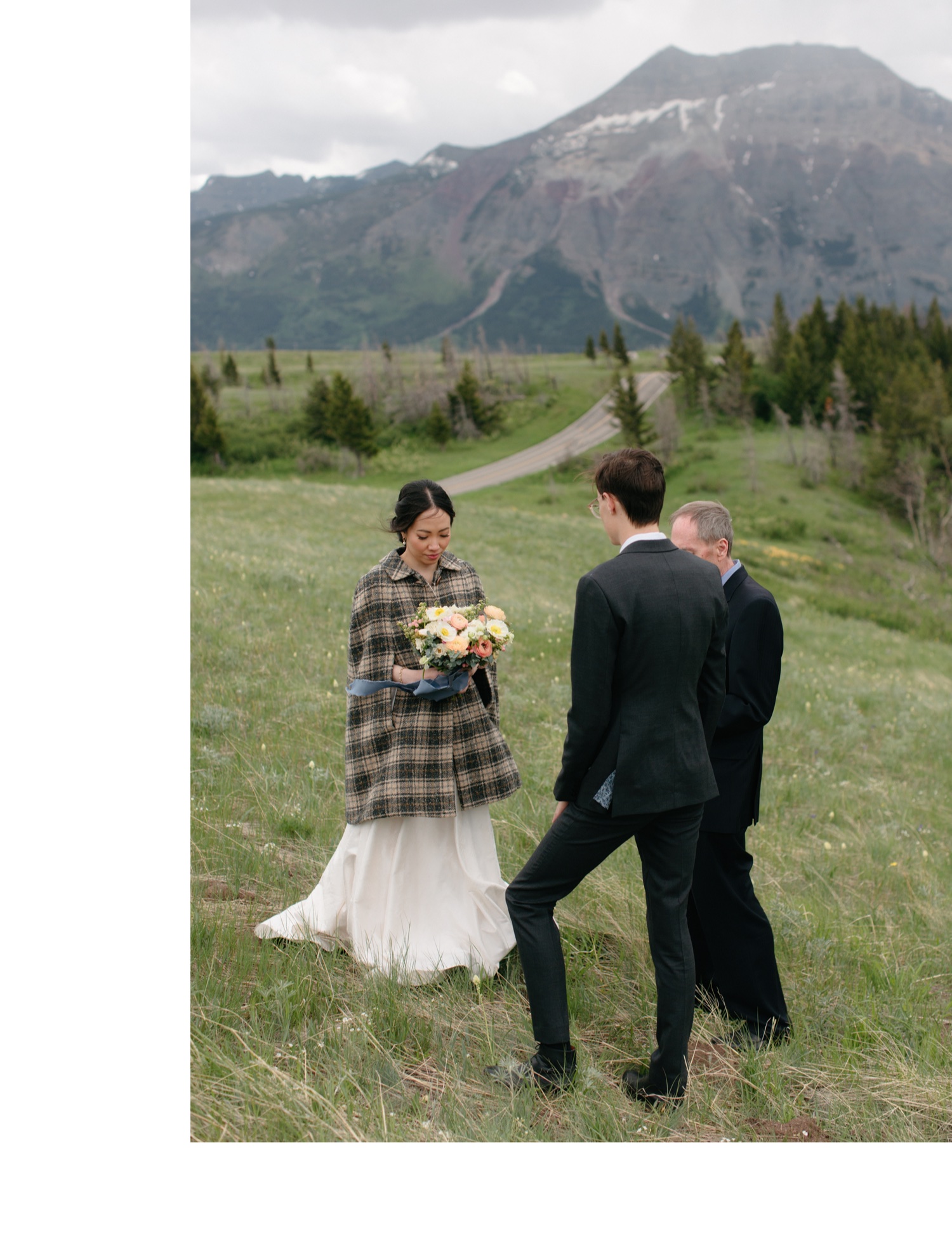 Bride wearing plaid cape for a windy ceremony in Waterton